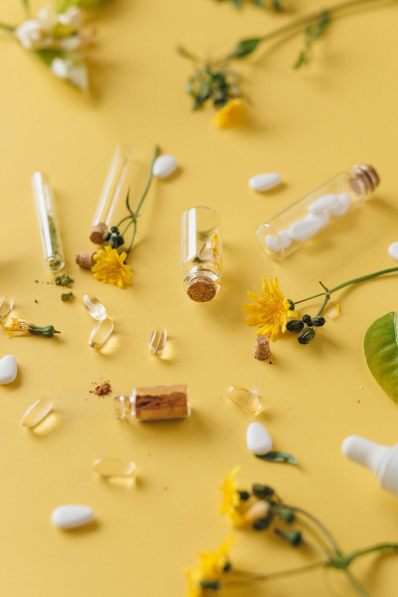 tiny bottles and pillows on a yellow background with white flowers
